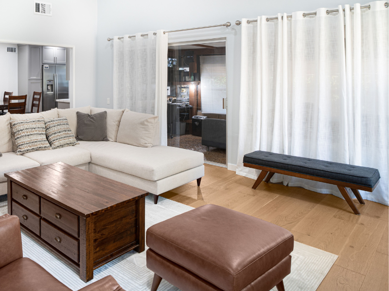 leather ottoman in a living rooom with sectional off white sofa 
