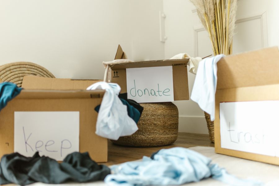 Declutter wardrobe: keep, donate and trash boxes 